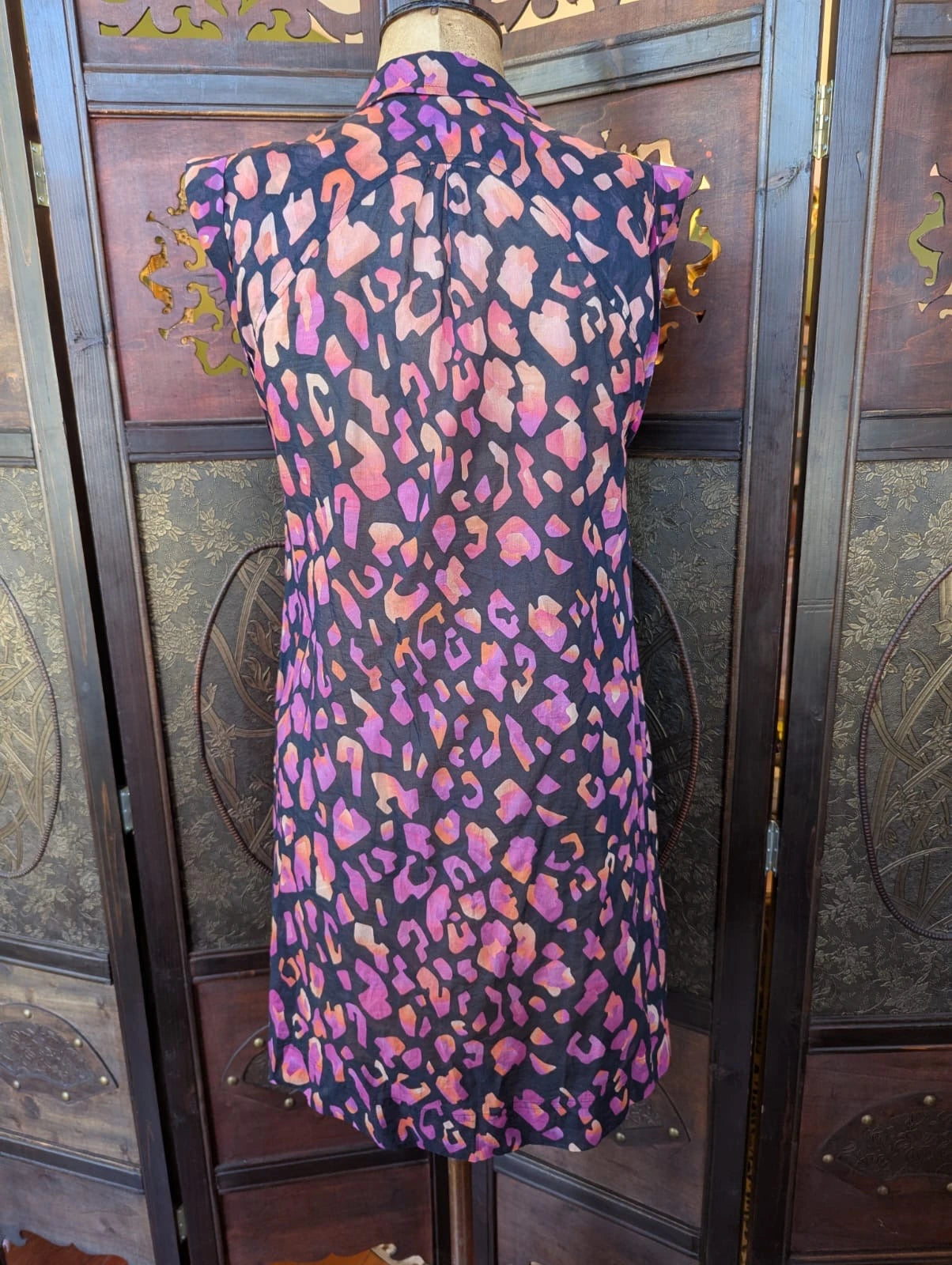 Broochella The Stylist's Closet Matthew Williamson designer black, purple and pink cotton leopard print dress on a mannequin against a decorative wall.