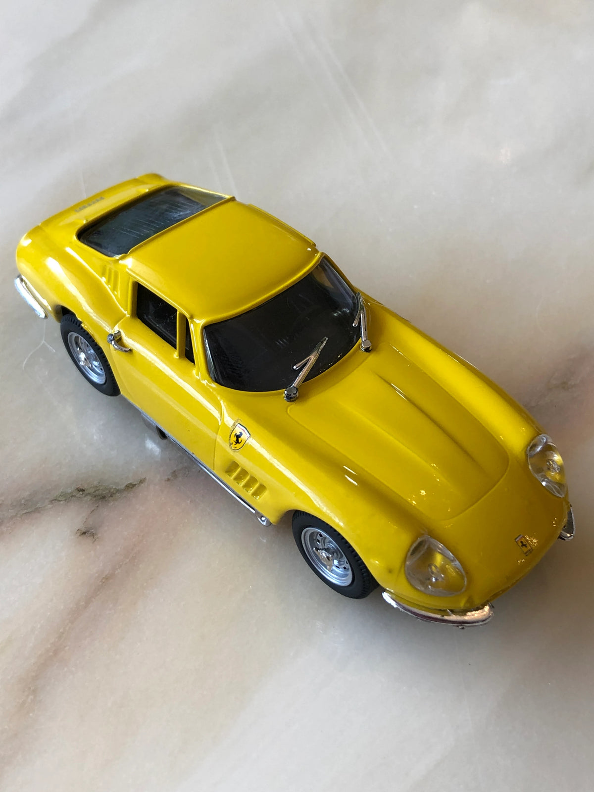 Broochella Men's Giallo Fiorano No.275 Vintage Ferrari Racing Brooch in bright yellow, featuring a classic Italian sports car design, Ferrari shield emblem, black windows, chrome detailing and silver wheels