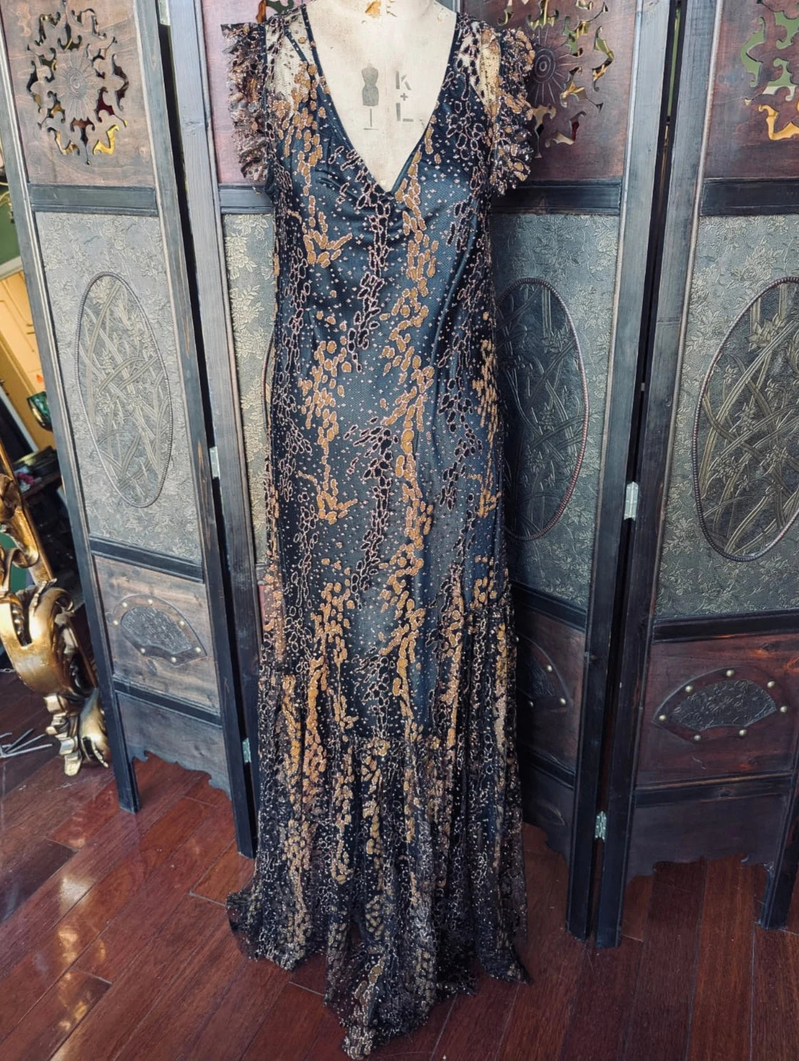 Broochella Opening Ceremony maxi Evening/cocktail dress. It has black & copper metallic, sheer outer and a black satin slip. Size – US 4. It is pictuers 