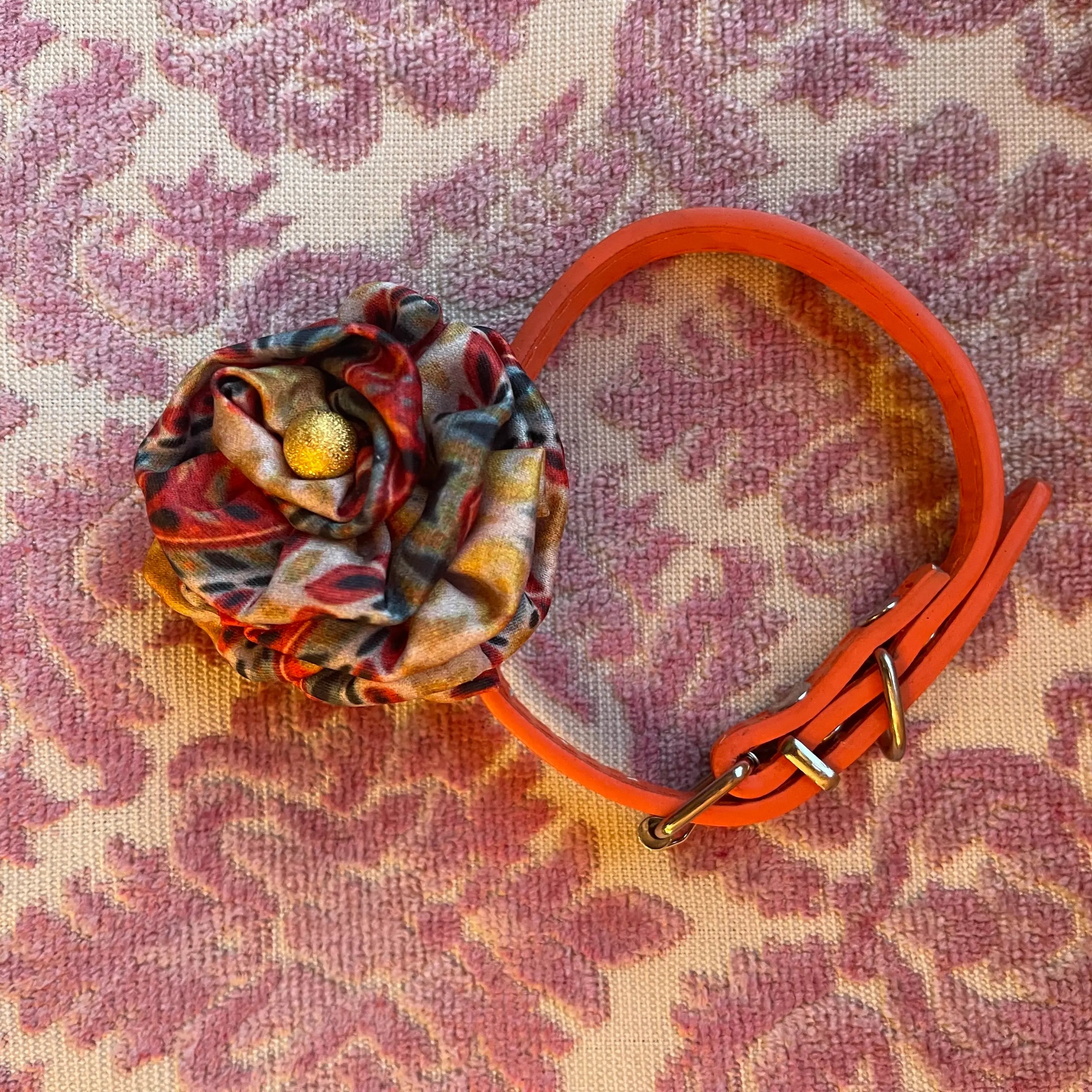 Broochella poochella bougainville hanmade flower pet collar. Pictured on a pink damask background